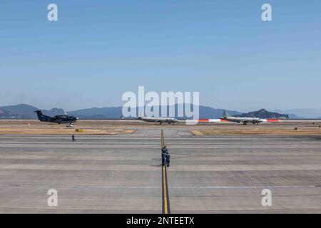 Japan Maritime Self-Defense Force OP-3C, P-3C and a US-2 taxi off the runway following a capabilities demonstration at Marine Corps Air Station Iwakuni, Japan, Feb. 27, 2023. The demonstration included a U.S. Marine Corps UC-12W Huron assigned to Headquarters and Headquarters, MCAS Iwakuni; two F-35B Lightning IIs and a KC-130J Super Hercules assigned to Marine Aircraft Group (MAG) 12, 1st Marine Aircraft Wing (MAW); three U.S. Navy F/A-18E Super Hornets, an F/A-18F Super Hornet, EA-18G Growler, E-2 Hawkeye, and C-2 Greyhound assigned to Carrier Air Wing (CVW) Five; and one JMSDF US-2,  EP-3, Stock Photo