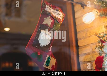 Christmas market details with New Year decorations and multicolored flags, garlands and festoons, Xmas atmosphere, fair interior, retail and store wit Stock Photo