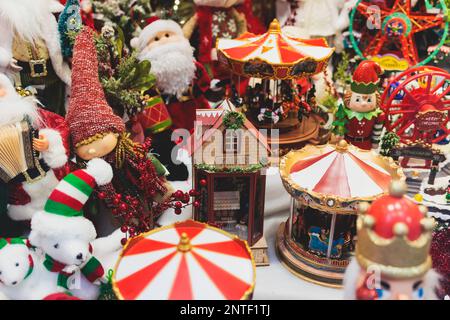 Christmas market details with New Year decorations and multicolored flags, garlands and festoons, Xmas atmosphere, fair interior, retail and store wit Stock Photo