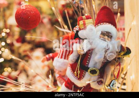 Christmas market details with New Year decorations and multicolored flags, garlands and festoons, Xmas atmosphere, fair interior, retail and store wit Stock Photo