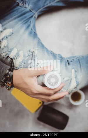relaxing concept, the man using wireless portable speaker for music listening. Stock Photo