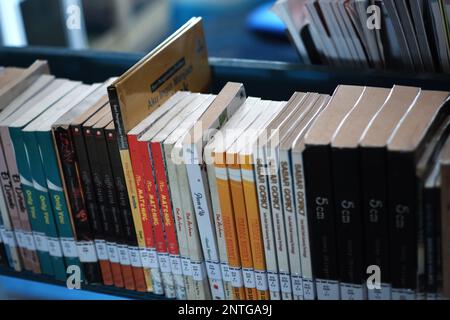Close Up, There Are Several Arrangement Of Books With Various Cover Colors, On An Iron Shelf Stock Photo