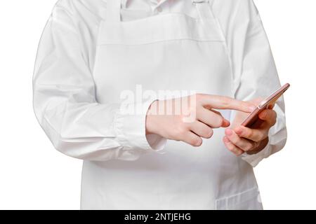 Man chef presses his finger on the screen in the phone on a isolated white background. Stock Photo
