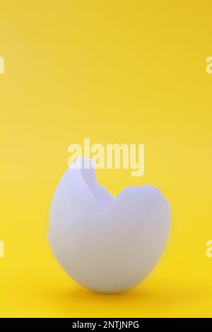 Eggshell on a yellow background. Broken cracked egg. Easter, birth. Copy space Stock Photo