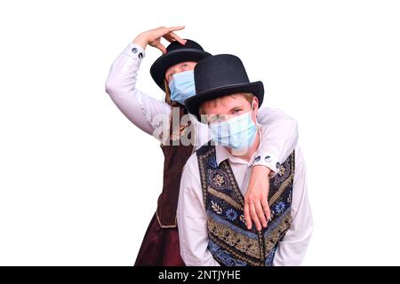 Actors, isolated on a white background wearing medical masks on their faces Stock Photo