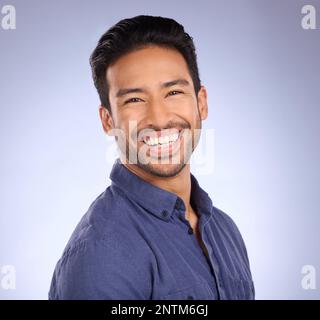 Business man, smile and portrait of a marketing manager from the Philippines in a studio. Isolated, blue background and happiness of a businessman and Stock Photo