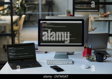 Horizontal image of workplace of developer with computers in IT office Stock Photo