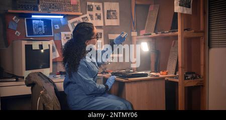 Laptop repair engineer diagnostics random access memory or ram memory in old computer lab. Computer repairman working on repairing computer in retro I Stock Photo