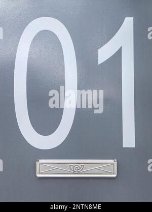 House number 01 over grey metal surface. Houses with personality concept Stock Photo