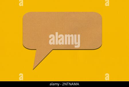 Brown paper speech bubble on yellow paper background. Paper blank of ...