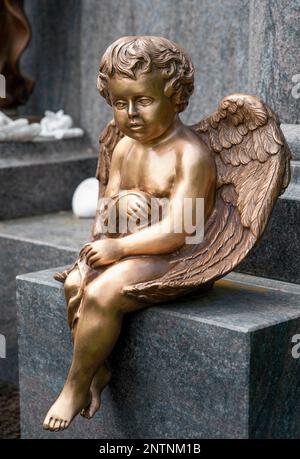Golden guardian angel with long cross necklace Stock Photo