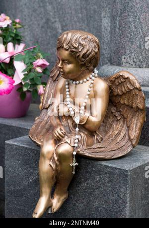 Golden girl guardian angel with long cross necklace Stock Photo