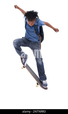 Showing off his mad skills. A young African-American boy doing a trick on his skateboard. Stock Photo