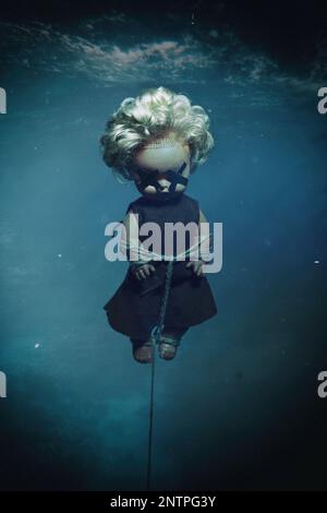 bound doll with covered eyes underwater Stock Photo