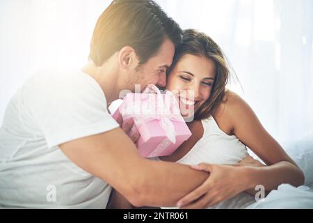 Because youre so special to me. Shot of a loving husband giving his wife a gift. Stock Photo