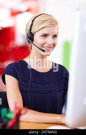 Putting in the man hours. Cropped shot an attractive young businesswoman working on her computer. Stock Photo
