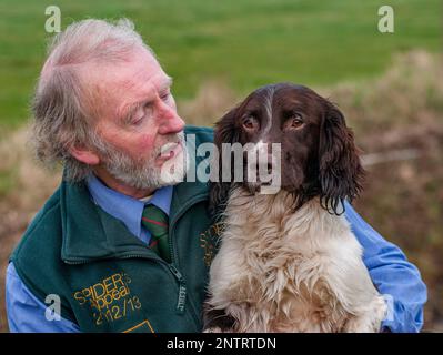 BARRY ATKINSON with his English Springer Spaniel called Spider. After a record of beating or picking-up on 1,000 different shoots in 10 shooting seasons, for his charity, Spider's Appeal Stock Photo