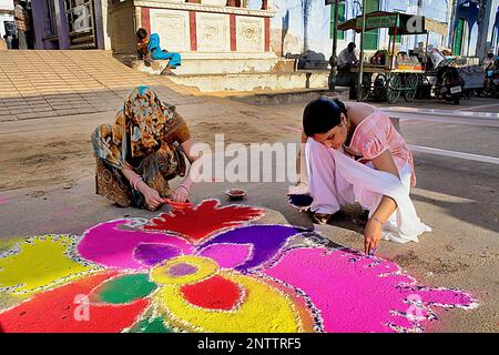 women making rangoli,Gangaur festival,pushkar, Rajasthan, india Stock Photo