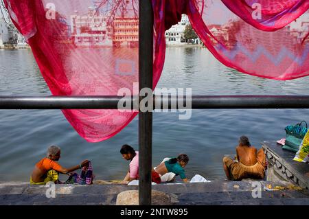 Women washing at Pichola Lake,Udaipur, Rajasthan, india Stock Photo