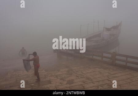 Hindu pilgrims take a holy bath, in Ganges river, Varanasi, Uttar Pradesh, India. Stock Photo