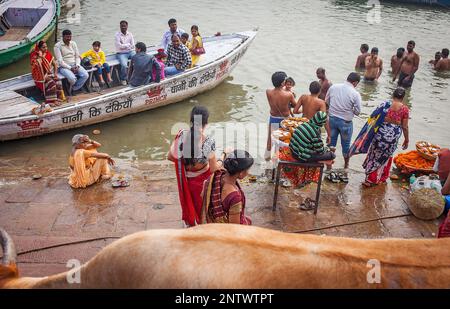 women and men praying and bathing, in the ghats of Ganges river, Varanasi, Uttar Pradesh, India. Stock Photo
