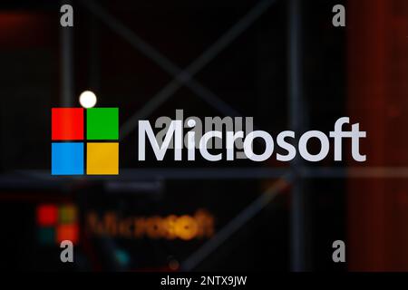 A Microsoft logo on a window at their computer research, and AI lab at 300 Lafayette St, New York, in Manhattan's SoHo. Stock Photo