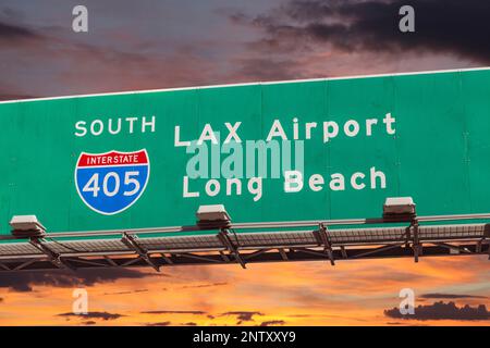 LAX Airport and Long Beach overhead freeway sign on Interstate 405 with sunset sky. Stock Photo