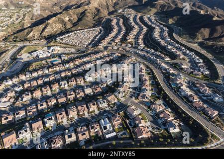 Aerial cityscape view of suburban tract homes with solar rooftops in the Santa Clarita community of Los Angeles County, California. Stock Photo
