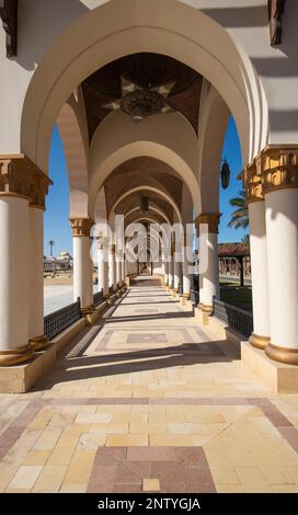 Corridor of arches diminishing to vanishing point at infinity abstract architecture corridor in tropical outdoor piazza courtyard Stock Photo