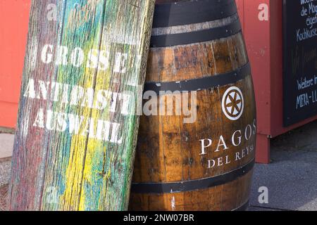 Summery image of an old oak barrel with an antique wooden board leaning against it. Stock Photo