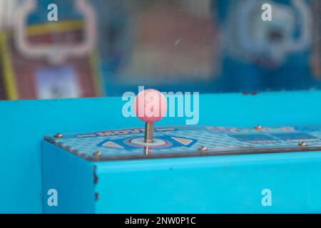 Close-up on the joystick of a claw machine. Stock Photo