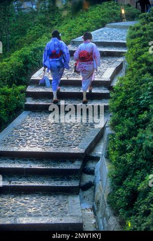women wearing kimono, they are walking up the stairs to the Ryozen Kannon temple ,Kyoto, Japan Stock Photo