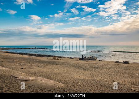 February 12, 2023 - Ostia, Rome, Italy. The sea of Ostia, on the Roman coast, on a winter Sunday. People enjoy the public holiday by walking on the be Stock Photo