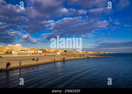 February 12, 2023 - Ostia, Rome, Italy. The sea of Ostia, on the Roman coast, on a winter Sunday. People enjoy the public holiday by walking on the be Stock Photo