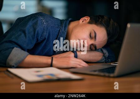 Closeup of young man manager sleeping at workdesk at office Stock Photo