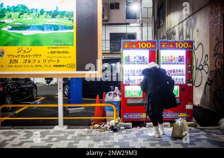 Man buying, drink vending machines, Omotesando street, Tokyo, Japan Stock Photo