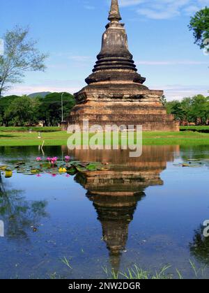 Thai temple and its reflection into the calm water, Wat Mahathat, Sukhothai, Thailand Stock Photo