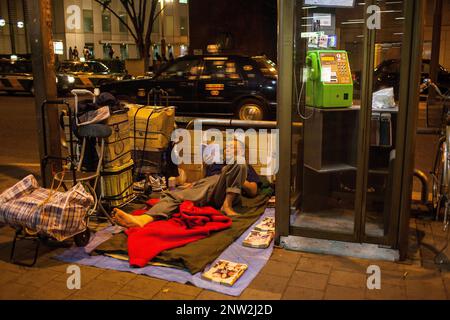 Homeless reading in Nishi Shinjuku.Shinjuku.Tokyo city, Japan, Asia Stock Photo