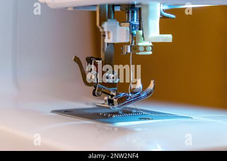 Part of the sewing machine. Close-up of the needle and sewing foot. Sewing production Stock Photo