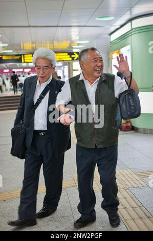 two drunk men in Shinjuku station.Shinjuku.Tokyo city, Japan, Asia Stock Photo