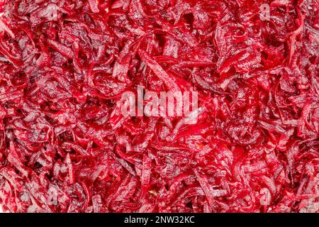 Vegetable background with close up of boiled grated beets. Vegan and vegetarian background Stock Photo