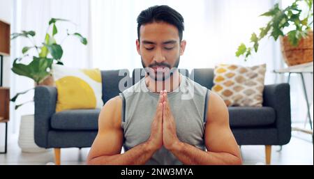 Meditation exercise, man yoga training and zen workout for spiritual health, relax for wellness and prayer hands for health in living room. Calm Stock Photo
