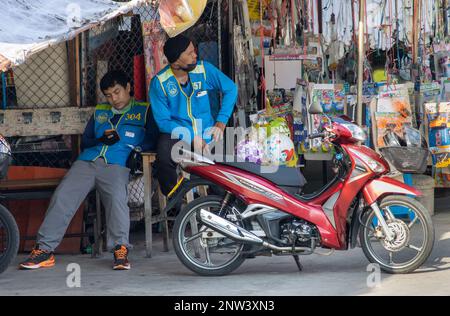 SAMUT PRAKAN, THAILAND, FEB 13 2023, Taxi drivers on motorbikes are waiting for passengers Stock Photo