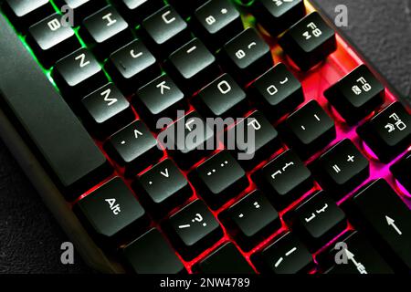 Modern keyboard with RGB lighting on grey table, closeup Stock Photo