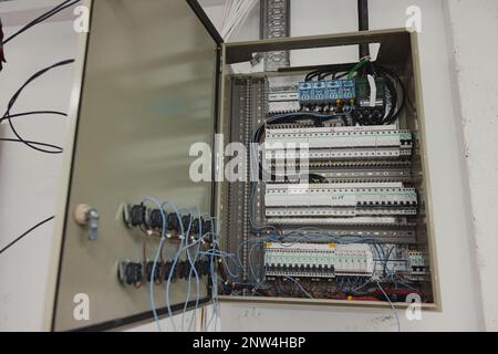 Electrical panel with wires and switches in a modern electrical installation. Stock Photo