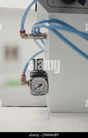 Ca close-up of a pressure gauge on a white wall in a factory Stock Photo