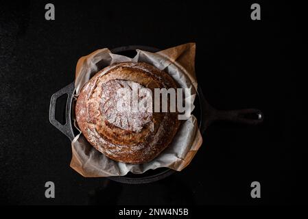 Freshly baked sourdough loaf in the pan Stock Photo