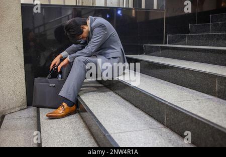 Salaryman sleeping after drink too much alcoholic beverages in Shinjuku station.Subway.Tokyo city, Japan, Asia Stock Photo