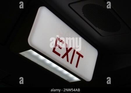 Exit sign on the top of an indoors door of an A330. Stock Photo