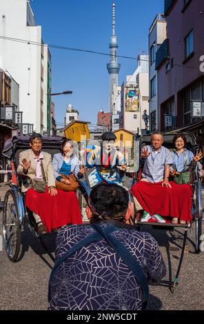 Tourists, Rickshaws, near Kaminarimon Dori.In background Tokyo Sky tree.Asakusa.Tokyo city, Japan, Asia Stock Photo